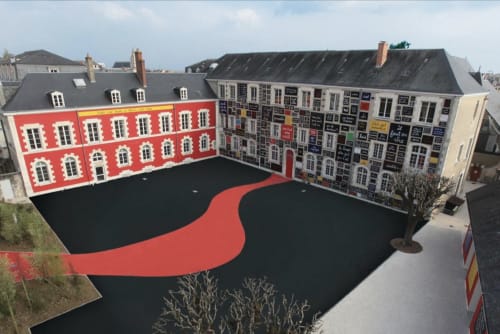 Cour Locacharme à Blois avec motifs géométriques rouges et noirs, bordée de bâtiments historiques aux couleurs vibrantes