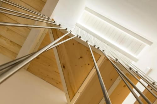 Modern wooden ceiling with metal rails and skylights in eco-friendly hotel room at In Centro Da Viola, Olbia