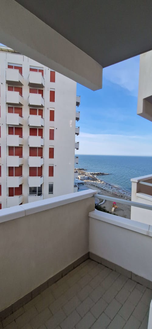 Balcony view from Lamar Suites Seafront Apartments in Misano Adriatico overlooking the Adriatic Sea and white apartment