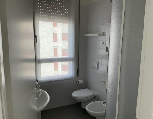 Modern bathroom in Lamar Suites Seafront Apartments, Misano Adriatico with toilet, sink, shower and window with sea view