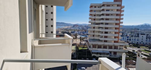 Balcony view from Lamar Suites Seafront Apartments in Misano Adriatico, overlooking harbor, coastal town, and mountains