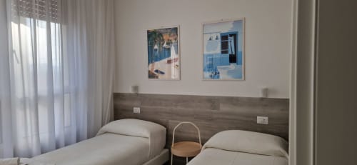 Modern twin bedroom at Lamar Suites Seafront Apartments in Misano Adriatico with wood headboard and Mediterranean coastal