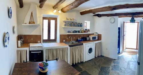Amplia y cómoda cocina tradicional Alpujarreña con vigas de castaño, mesa comedor y detalles de decoración de Casa Josefa Capileira