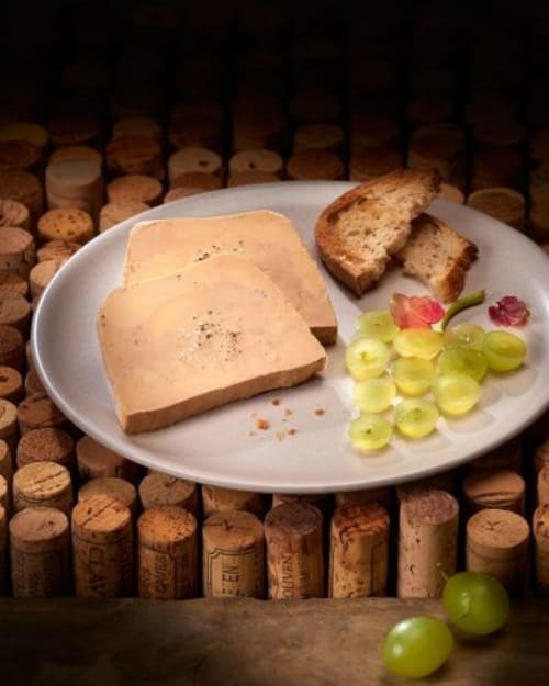 Foie gras platter with toasted bread and grapes at Domaine De Campagnac, Carsac-Aillac