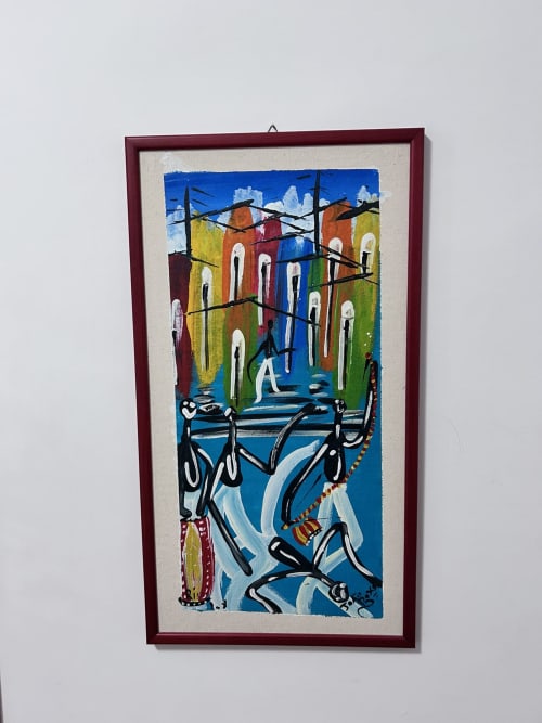 Colorful framed artwork depicting bicycles and a figure with vibrant buildings in Rome, guest house decor