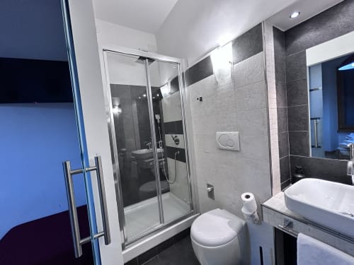 Modern bathroom in De Luxe Double Room at Maison Vanicana Guest House Rome with shower, toilet, and sink