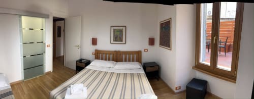 De Luxe Double Room at Maison Vaticana Guest House Rome with wooden bed, terrace access, and modern amenities