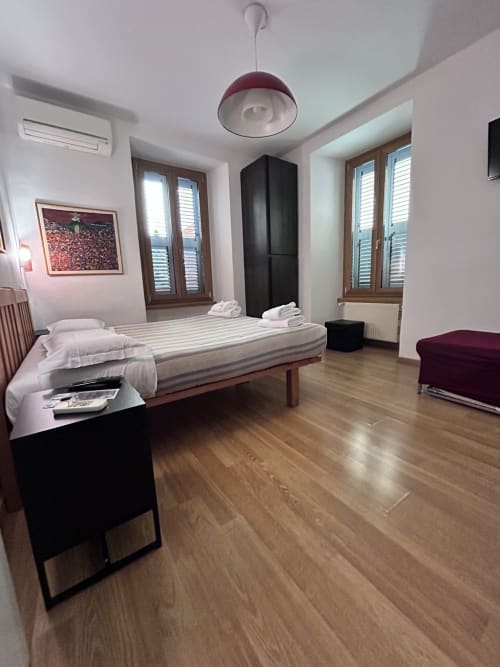 De Luxe Double Room D3 at Maison Vaticana Guest House Rome - spacious bedroom with bed, wooden floors, modern furnishings