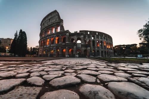 The Colosseum at dusk, Rome - iconic landmark near Hotel Fiori with ancient architecture and golden lighting