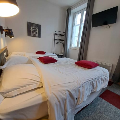 Chambre moderne aux Deux Porches avec lits jumeaux, oreillers rouges, TV murale et balcon vitré à Verrières