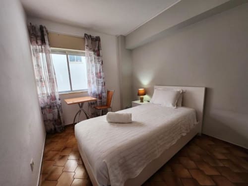 Bright bedroom at Casa do Sol Algarve Lagos with twin beds, work desk, and natural light from windows