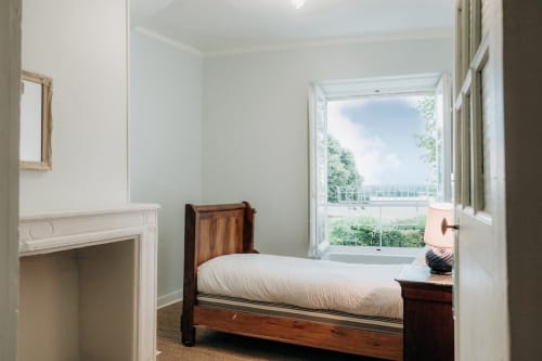 Antique wooden bed in front of the fireplace