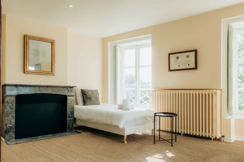 Single bed next to a fireplace