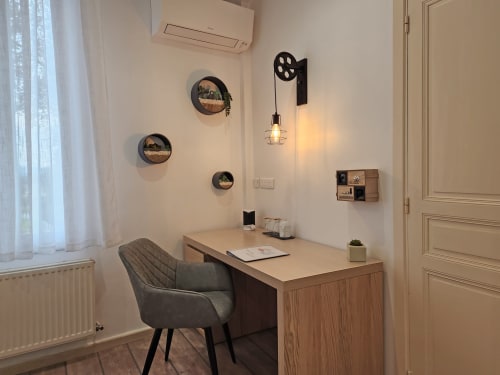 Modern workspace at Domaine à l'Aise with desk, chair, wall décor, and pendant lighting in Saint-Pargoire