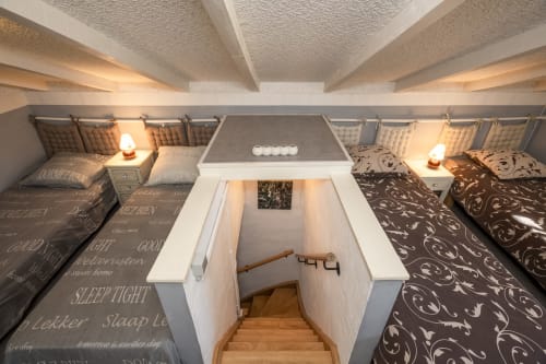 Cozy bedroom at Domaine à l'Aise B&B in Saint-Pargoire with twin beds, warm lighting, and modern amenities