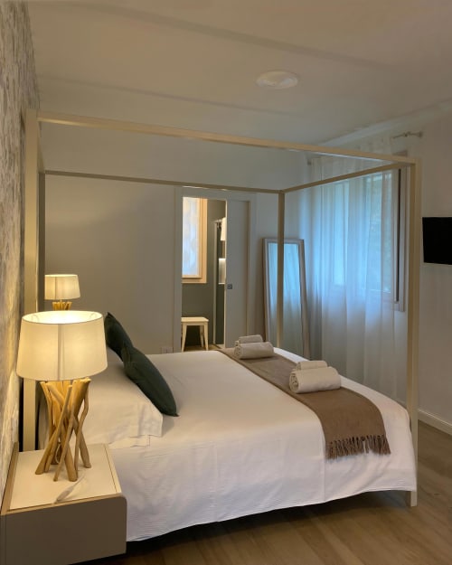 Verdolivo B&B bedroom in Sale Marasino with canopy bed, modern furnishings, and elegant décor