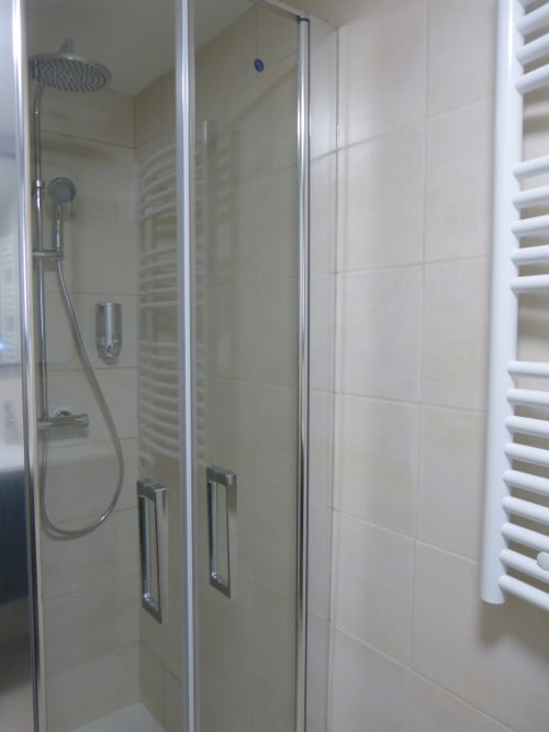 Modern glass shower enclosure with rainfall showerhead in Cérise room at Villa Thébaïde, Laudun L'Ardoise