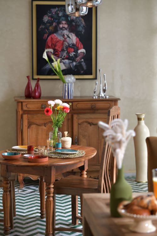 Elegant dining room at Riad Palau Marrakech with wooden furniture, fresh flowers, and traditional decor