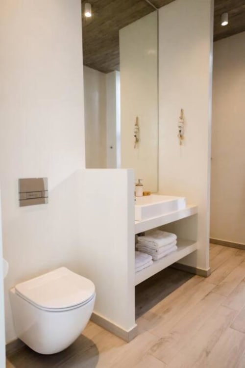 bathroom of the villa for rent in Tinos with sink toilet and shower area