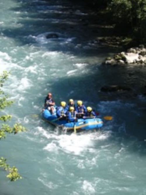 Whitewater rafting group navigating rapids near Aime la Plagne, France adventure activities