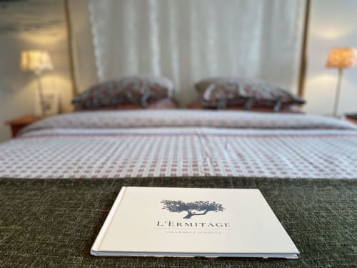 L'Ermitage hotel brochure on bed in Saint-Vaast-la-Hougue, French coastal B&B room