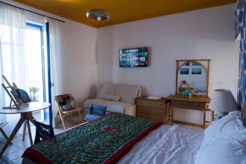 Spacious Foce Deluxe room at Le Vajane B&B in Torino di Sangro with sea view balcony, bed, sofa, wooden furnishings, and