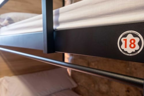 bunk beds in mixed dormitory at Albergue Santiago de Caminha hostel in Caminha, Portugal -Room in a mixed dormitory with air conditioning and Shared bathroom with shower. Tiled floor. Max occupancy: 1 person. Caminho Português da Costa - Camino de Santiago. Coastal way Senda Litoral