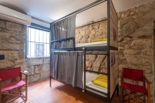 bunk beds in mixed dormitory at Albergue Santiago de Caminha hostel in Caminha, Portugal -Room in a mixed dormitory with air conditioning and Shared bathroom with shower. Tiled floor. Max occupancy: 1 person. Caminho Português da Costa - Camino de Santiago. Coastal way Senda Litoral