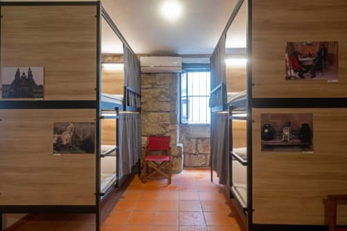 bunk beds in mixed dormitory at Albergue Santiago de Caminha hostel in Caminha, Portugal -Room in a mixed dormitory with air conditioning and Shared bathroom with shower. Tiled floor. Max occupancy: 1 person. Caminho Português da Costa - Camino de Santiago. Coastal way Senda Litoral