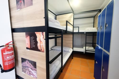 bunk beds in mixed dormitory at Albergue Santiago de Caminha hostel in Caminha, Portugal -Room in a mixed dormitory with air conditioning and Shared bathroom with shower. Tiled floor. Max occupancy: 1 person. Caminho Português da Costa - Camino de Santiago. Coastal way Senda Litoral