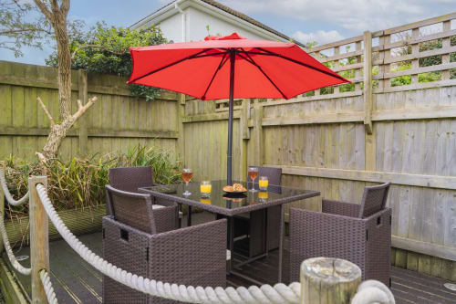 Enjoy a bar b que and the scenic outdoor eating area on the decking at Meadow Rise, a picturesque Cornish holiday property in St Columb Major, Cornwall. Surrounded by lush greenery and bathed in natural sunlight, this charming space offers the perfect setting for al fresco dining experiences. Enjoy family time while savoring delicious meals with loved ones.