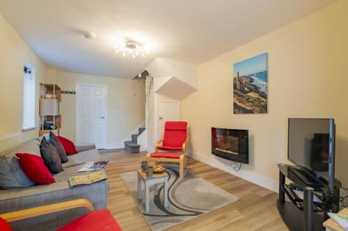 Relaxing lounge area at Meadow Rise, a cozy Cornish holiday property situated in the charming village of St Columb Major, Cornwall. Sink into plush furnishings amidst tasteful decor, creating a welcoming atmosphere for guests to unwind and socialize, promising a memorable stay in the heart of Cornwall's countryside.