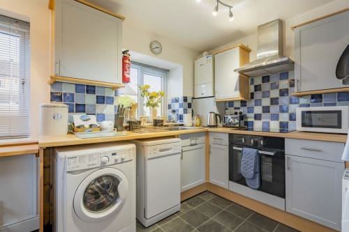 Modern and fully-equipped kitchen at Meadow Rise, a charming Cornish holiday property nestled in the scenic village of St Columb Major, Cornwall. Prepare delicious meals with ease amidst sleek countertops and state-of-the-art appliances. Experience the joy of cooking while making your stay in Cornwall truly memorable.