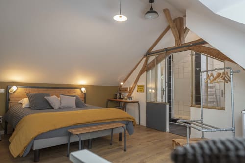 Guest room with cozy bed and industrial decoration