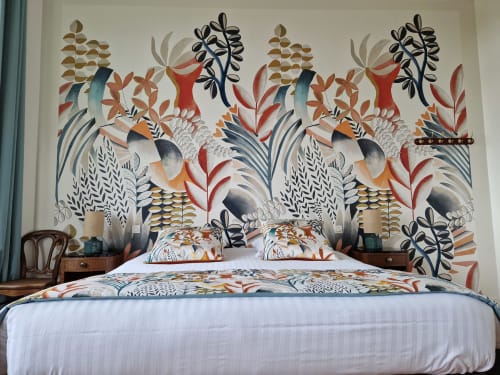 Bedroom with botanical wallpaper mural at Domaine de l'Oie Rouge, bed with patterned bedding, nightstands, and teal curtains.