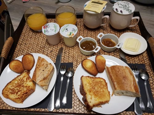 Breakfast tray at Domaine de l'Oie Rouge with French pastries, toast, orange juice, butter, and jam served in Loire Valley