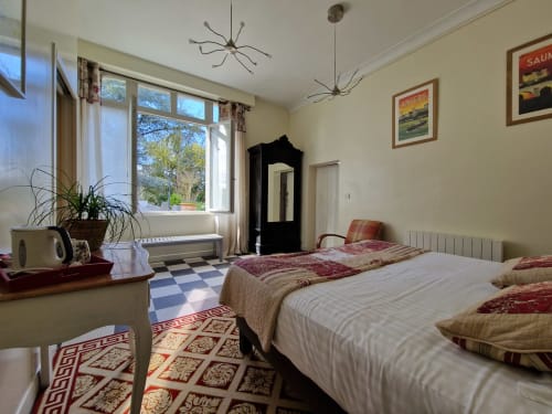 Coriandre bedroom at Domaine de l'Oie Rouge with twin beds, garden view windows, and Loire valley decor