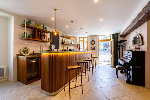 La Maison George apartment bar and lounge with wooden counter, bar stools, piano, and elegant furnishings in Flavigny sur