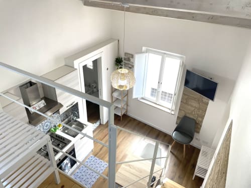 Modern loft apartment at Catalogna10 Rooms in Alghero with mezzanine bedroom, kitchen, and living area