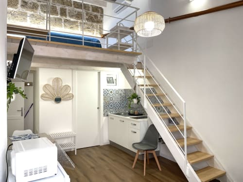 Modern loft apartment at Catalogna10 Rooms in Alghero with mezzanine bedroom, kitchenette, and wooden stairs