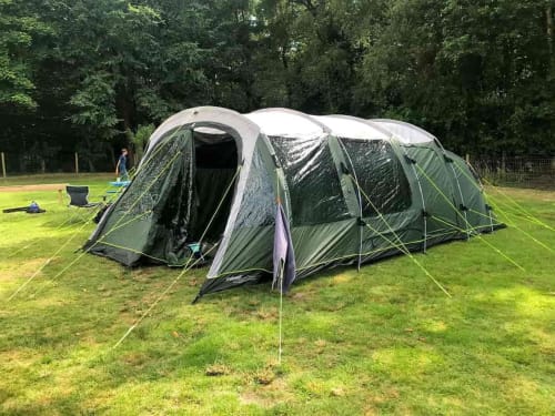 Large family camping tent pitched on green grass at Postwood Gardens Campsite in Kentisbeare