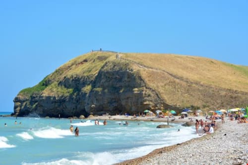 Pittoresca baia con acque turchesi, scogliere dorate e spiaggia sabbiosa a Torino di Sangro, Italia