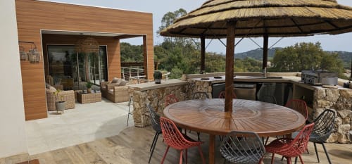 Luxury villa terrace at Villas-Majos with dining table, lounge seating, and mountain views in Porto-Vecchio