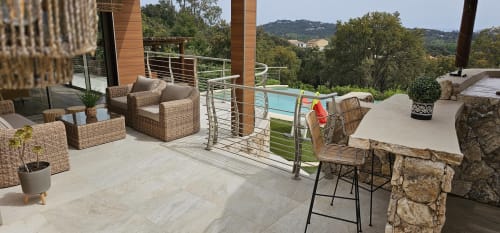 Luxury villa terrace at Villas-Majos with pool view, wicker seating, and Corsican hillside landscape