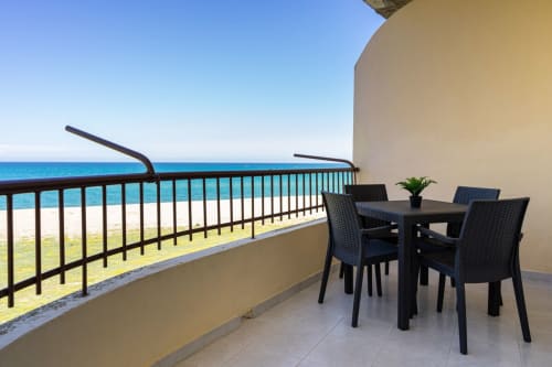 Balcone fronte mare con tavolo da pranzo a Lux Immobiliare, Marina di Strongoli, vista sul mare turchese e spiaggia sabbiosa
