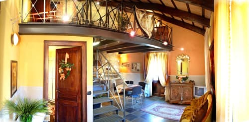Le Calle Apartment at Dimora i Manichei in Monforte d'Alba features a spacious living area with mezzanine, elegant