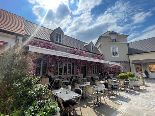 Outdoor terrace with blooming flowers at Residence Disneyland Place Toscane restaurant, Serris France