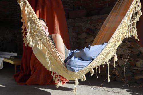 Guest relaxing in hammock at CasaRosada B&B in Vidracco, Italy