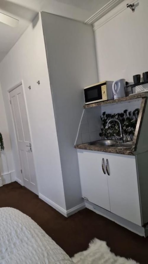 Sink in room and fridge microwave 