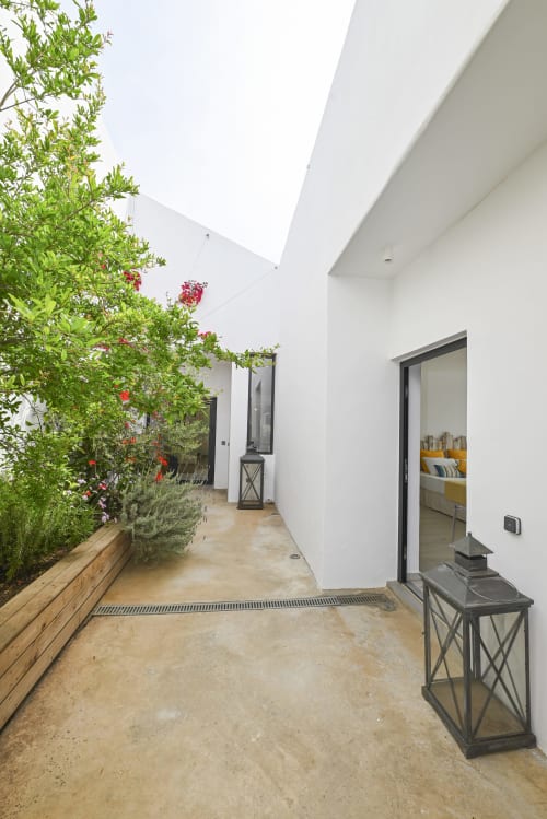 architect-designed villa rental in Greece, view of the main entrance and the bedrooms in the interior patio